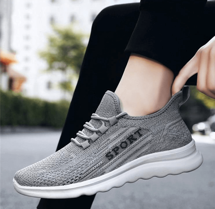 Stylish gray breathable men's sneakers with elastic lace-up design and comfortable mesh upper for flexibility and style.